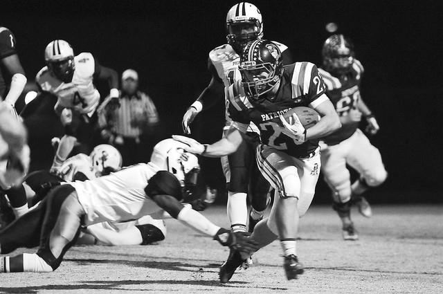 Liberty running back Tyler Parvin (23) breaks free from a Canyon Springs defender during the Sunrise Region semifinal game at home in Henderson, Friday, Nov. 15, 2013. The Liberty Patriots were do ...