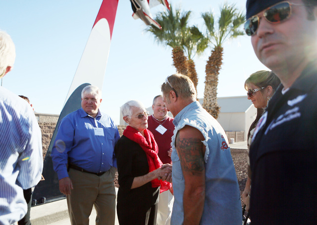 Shirley Buckley, center, shakes hands with Rick Dale during a rededication ceremony for her late husband Capt. Gene Devlin outside the Thunderbirds Hangar at Nellis Air Force Base Friday, Nov. 15, ...