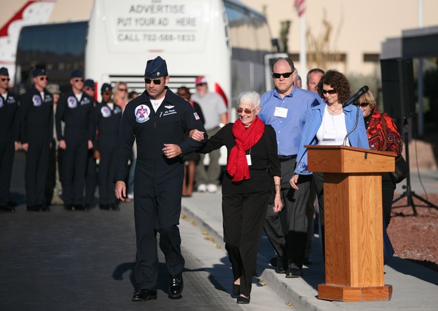 Lt. Col. Greg Moseley (CQ) left, escorts Shirley Buckley, center, during the start of a rededication ceremony for Buckley's late husband Capt. Gene Devlin outside the Thunderbirds Hangar at Nellis ...