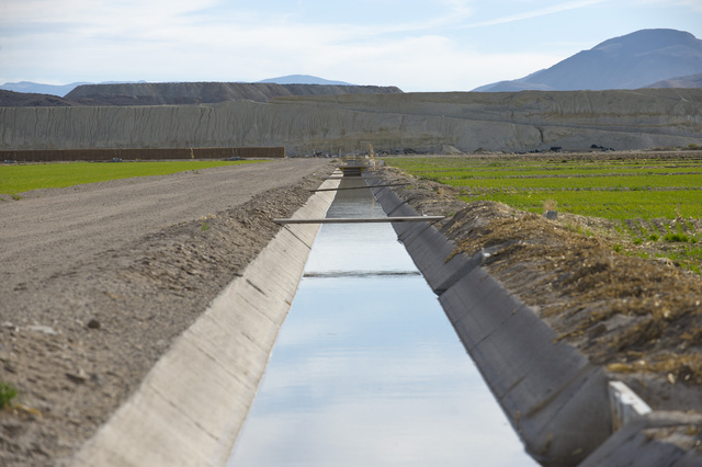 In this photo taken Oct. 26, 2009, irrigation ditches and crop fields are located right in the center of the Uranium plume spreading from the former Anaconda copper mine site near Yearington, Nev. ...