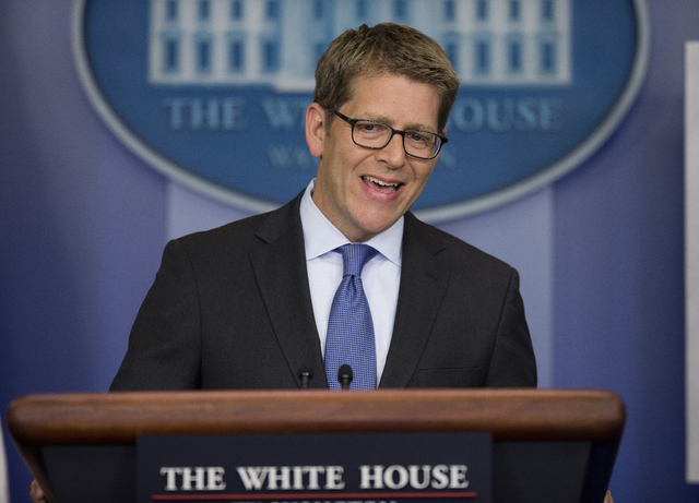 White House press secretary Jay Carney answers a question during the daily press briefing, Monday, Dec. 2, 2013, in the White House briefing room in Washington. Carney answered questions on the on ...