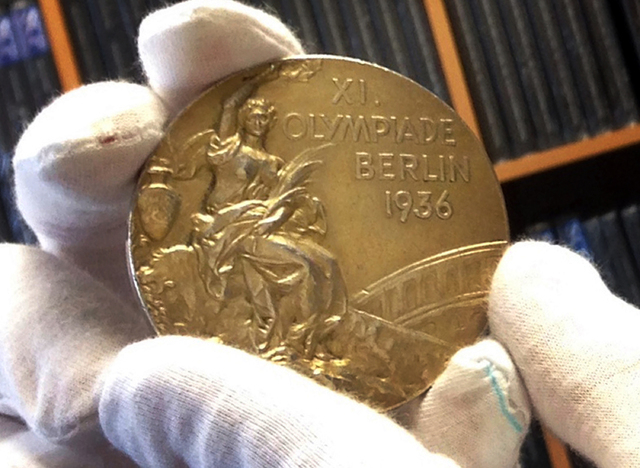 This Nov. 19, 2013 photo shows track and field star Jesse Owens' gold medal is displayed from his 1936 Olympics win at the SCP Auctions in Laguna Nigel, Calif. One of the four Olympic gold medals ...