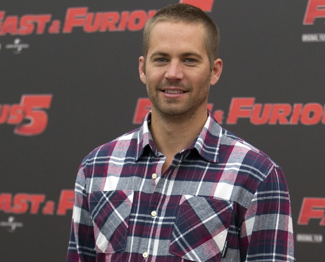 In this April 29, 2011 file photo, actor Paul Walker poses during the photo call of the movie "Fast and Furious 5," in Rome. The industrial neighborhood where he died in a car crash is known to at ...