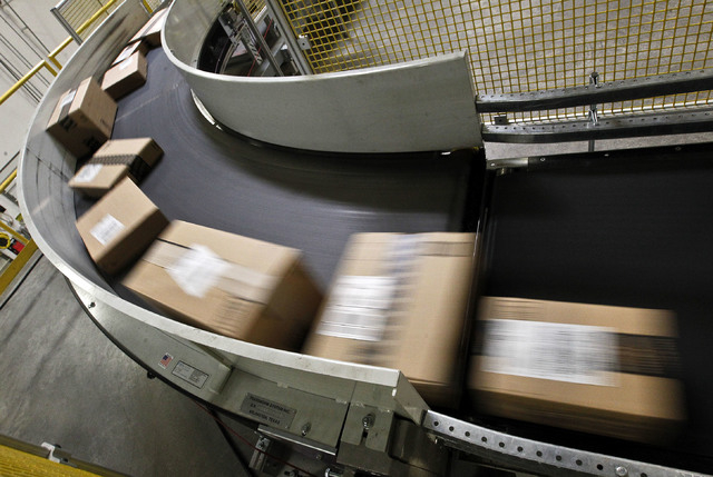 In this  Monday, Nov. 26, 2012, file photo. packages are ready to ship move along a conveyor belt at the Amazon.com 1.2 million square foot fulfillment center, in Phoenix.  Millions of shoppers ar ...