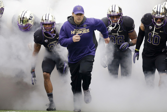 FILE - In this Nov. 29, 2013 file photo, Washington head coach Steve Sarkisian runs onto the field before NCAA college football game against Washington State in Seattle. Sarkisian has accepted the ...