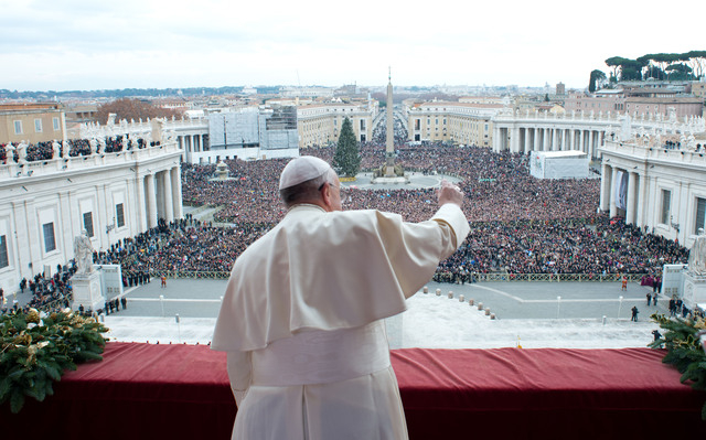 In this picture provided by the Vatican newspaper L'Osservatore Romano, Pope Francis delivers his "Urbi et Orbi" (to the City and to the World) message from the central balcony of St. Pe ...