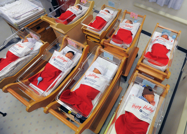 Newborns sleep in oversized red stockings in the nursery at Long Beach Memorial in Long Beach, Calif., on Monday, Dec. 23, 2013. For more than 50 years, babies born between Dec. 21-25 at Long Beac ...