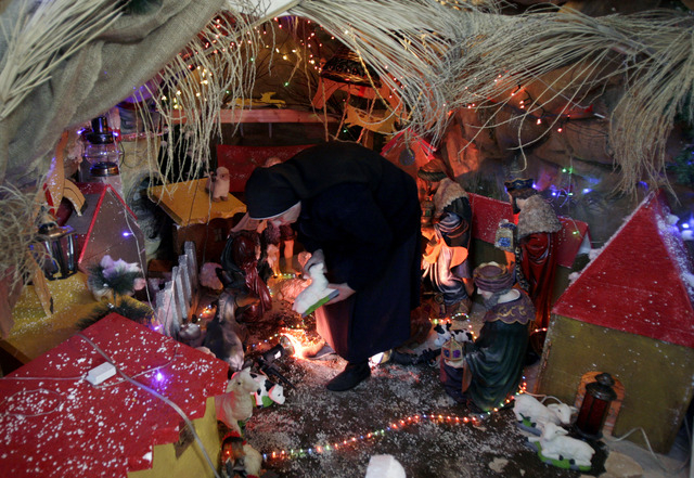 Palestinian nun Rosaria prepares a Nativity scene at the Latin Patriarch of Jerusalem Church of Visitation, also known as St. Mary's Visitation Church, in preparation for Christmas in the northern ...