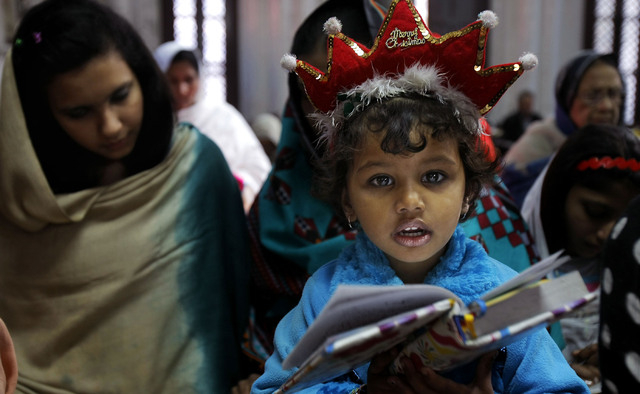 Pakistani Christians attend Christmas mass in Peshawar, Pakistan, Wednesday, Dec. 25, 2013.  Christians are a minority in Pakistan, they constitute about 1.6% of Pakistans population. (AP Photo/Mo ...