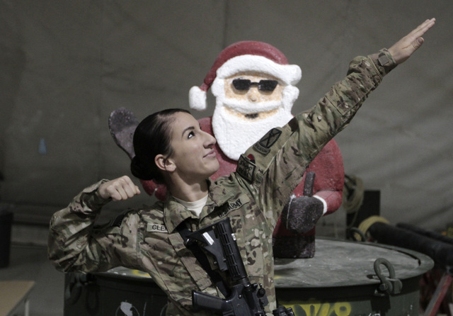 A U.S. soldier with the NATO- led International Security Assistance Force (ISAF) poses for photograph at a religious ceremony on Christmas in Logar province, eastern Afghanistan, Wednesday, Dec. 2 ...