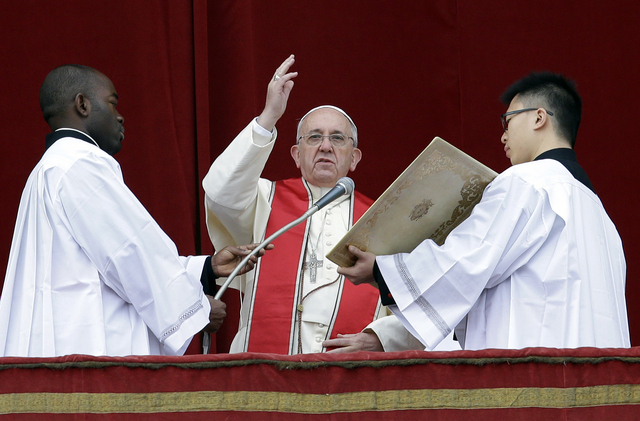 Pope Francis delivers his "Urbi et Orbi" (to the City and to the World) message from the central balcony of St. Peter's Basilica at the Vatican, Wednesday, Dec. 25, 2013. Pope Francis on ...