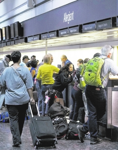 Passengers line up at the Allegiant Air ticketing counter at McCarran International Airport in Las Vegas on Sept. 20. McCarran is experiencing at least once a week a crush of passengers similar to ...