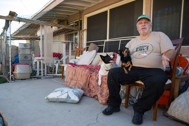 Everett Croxson, executive director of Foreclosed Upon Pets, Inc., talks about the 5-year-old nonprofit organization in his backyard Wednesday, Nov. 27, 2013. Weekly pet adoptions are held every S ...