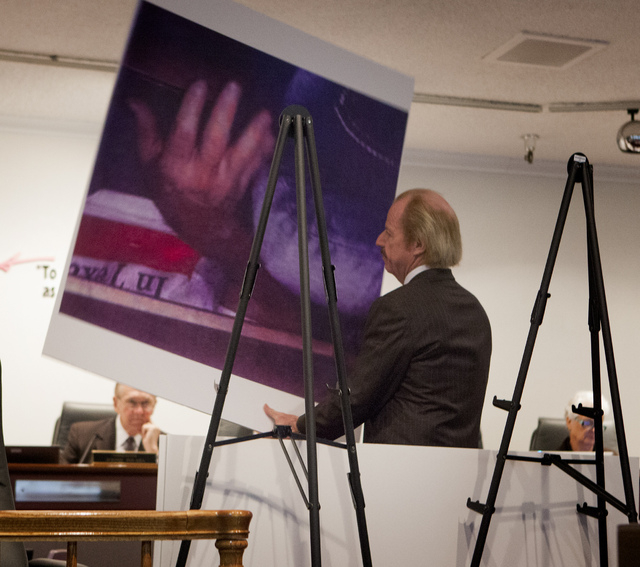 Jim Jimmerson, attorney for suspended Family Court Judge Steven Jones, holds a photo during the Nevada Commission on Judicial Discipline hearing at Las Vegas Convention Center Boardroom on Monday. ...