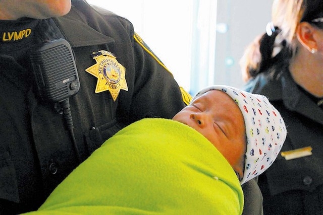 Officer Lourdes Smith holds the 3 week-old boy whose family Smith and Sgt. Richard Meyers helped in November. (Courtesy Las Vegas Metro PD)