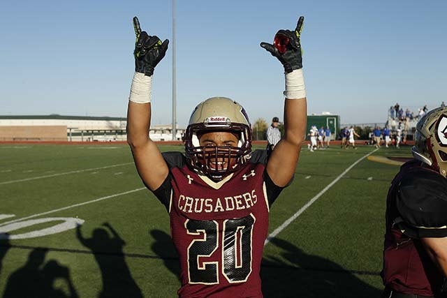 Faith Lutheran player Keenan Smith celebrates his team's victory over Lowry High School in the Division 1-A state semifinal football game at Faith Lutheran High School in Las Vegas Saturday, Nov.  ...