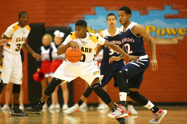 Clark's Colby Jackson (0) drives past Coronado's Eddie Austin (22) during a basketball game at Clark High School in Las Vegas on Monday, Dec. 2, 2013. (Chase Stevens/Las Vegas Review-Journal)