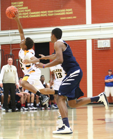 Clark's Keyshaun Webb (22) gains control of the ball over Coronado's Nick Howard (15) during a basketball game at Clark High School in Las Vegas on Monday, Dec. 2, 2013. (Chase Stevens/Las Vegas R ...