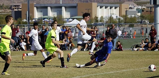 Eldorado's Andres Lua (20) watches his shot get past Green Valley goalie Victor Marquez (19) for a goal during their Sunrise Region championship soccer game at Heritage Park in Henderson on Nov. 9 ...