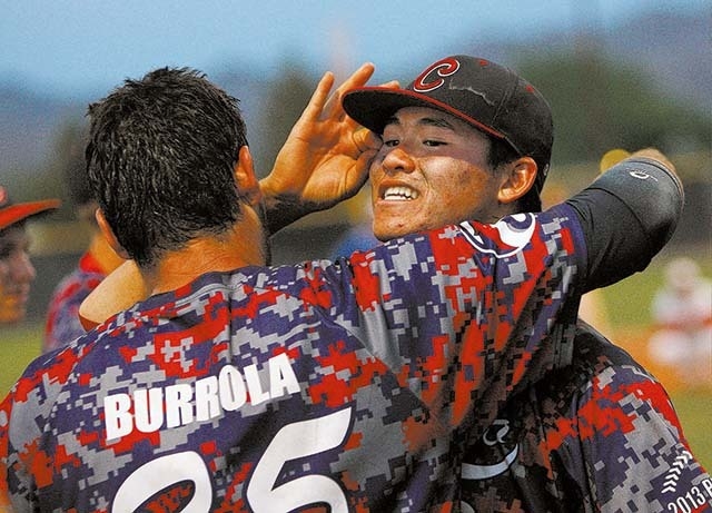Coronado High School players Chandler Blanchard, right, and Julian Burrola celebrate after defeating Bishop Gorman in their state baseball championship game in Henderson, Nev. May 18, 2013. (John  ...