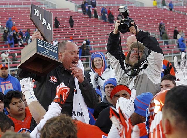 Bishop Gorman head coach Tony Sanchez congratulates his players after defeating Reed High School for the Division I Nevada State Football championship at Sam Boyd Stadium in Las Vegas on Dec. 7, 2 ...