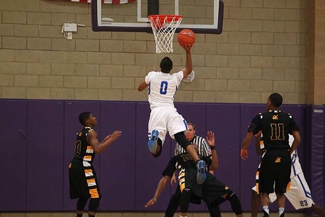 Desert Pines' Julian Jacobs shoots over Clark High School defense during the Division I-A Southern Region championship game at Sunrise Mountain High School in Las Vegas on Saturday, Feb. 16, 2013. ...