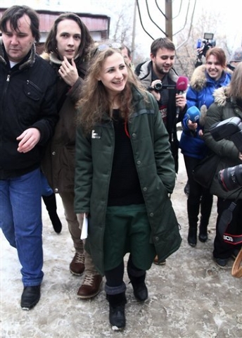Maria Alekhina, center, a member of the Russian punk band Pussy Riot speaks to the media at the Committee against Torture after being released from prison, in Nizhny Novgorod, Russia on Monday, De ...