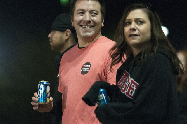 Josh Rindt and Heidi Zienter, from left, watch from the sideline during a kickball game between their team Kick'er & Lick'er and Cream Team at Desert Breeze Park in Las Vegas, Wednesday, Nov. 20,  ...