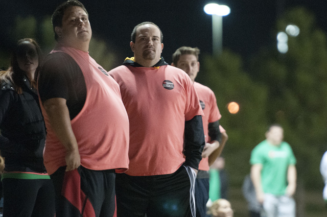 Chad Ovalle and Michael MacLeod, from left, members of kickball team Kick'er & Lick'er, watch the game against Cream Team from the sideline at Desert Breeze Park in Las Vegas, Wednesday, Nov. 20, ...