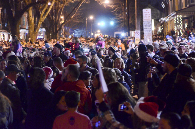 People fill the 400 block of Chestnut Street, Saturday, Dec. 21, 2013, in West Reading, Pa., where thousands of people gathered to sing Christmas carols in front of the home of Delaney "Laney" Bro ...