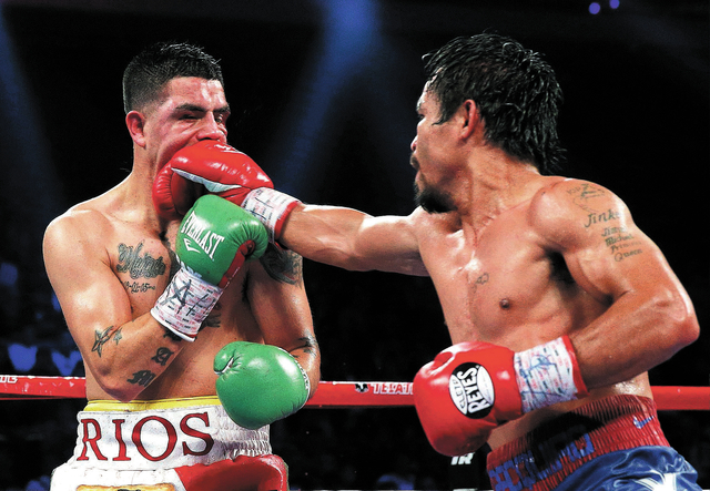 Manny Pacquiao, from the Philippines, right, lands a right to Brandon Rios of the United States during their WBO international welterweight title fight Sunday, Nov. 24, 2013, in Macau. Pacquiao de ...