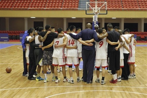 Dennis Rodman huddles with North Korean basketball players and fellow former NBA stars at a practice session in Pyongyang, North Korea on Tuesday, Jan. 7, 2014. Rodman came to the North Korean cap ...