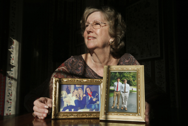 Penny Trusty, 74, a retired software designer, shows photographs of her five grandchildren in her home in Rockville, Md. She said she worries about her grandchildren, about the "lowering of moral ...