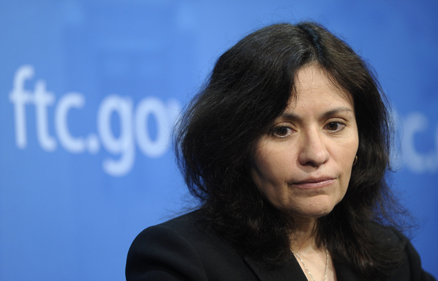 Federal Trade Commission (FTC) Chair Edith Ramirez pauses during a news conference at the FTC in Washington, Wednesday, Jan. 15, 2014, where she announced Apple will refund $32.5 million to consum ...