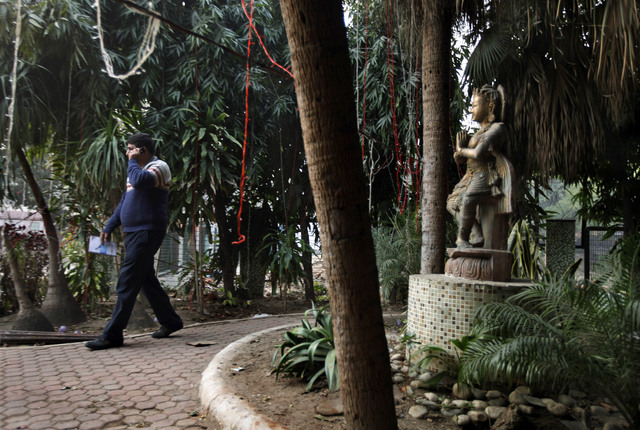 An Indian investigator speaks on his phone Wednesday at the spot where police say a Danish tourist was gang-raped in New Delhi. The 51-year-old tourist was attacked Tuesday near a popular shopping ...