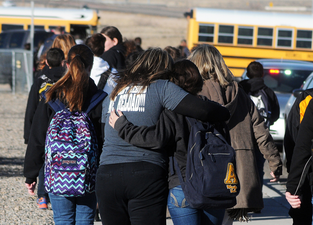 Students are escorted from Berrendo Middle School after a shooting incident, Tuesday, Jan. 14, 2014, in Roswell, N.M. Roswell police said the suspected shooter was arrested at the school, but auth ...