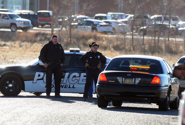 Law enforcement personnel set up a perimeter following a shooting at Berrendo Middle School in Roswell, Tuesday, Jan. 14, 2014, in Roswell, N.M. A shooter opened fire at the middle school, injurin ...