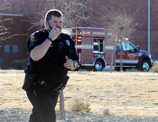 Law enforcement personnel set up a perimeter after a shooting at Berrendo Middle School, Tuesday, Jan. 14, 2014, in Roswell, N.M. A shooter opened fire at the middle school, injuring at least two ...