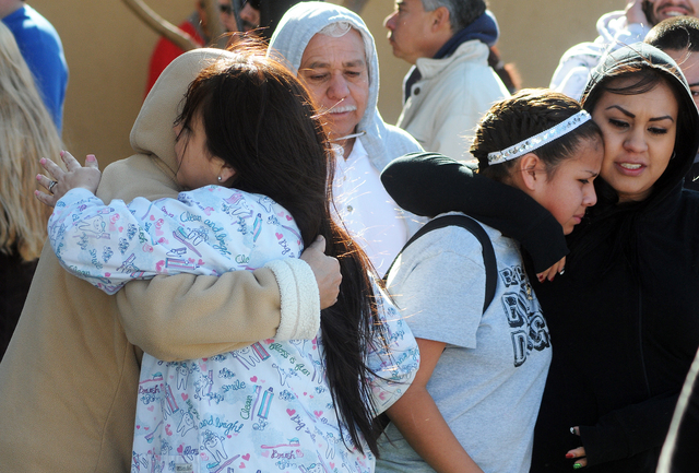 Students are reunited with families at a staging ground area set up at the Roswell Mall following a shooting at Berrendo Middle School, Tuesday, Jan. 14, 2014, in Roswell, N.M. A shooter opened fi ...