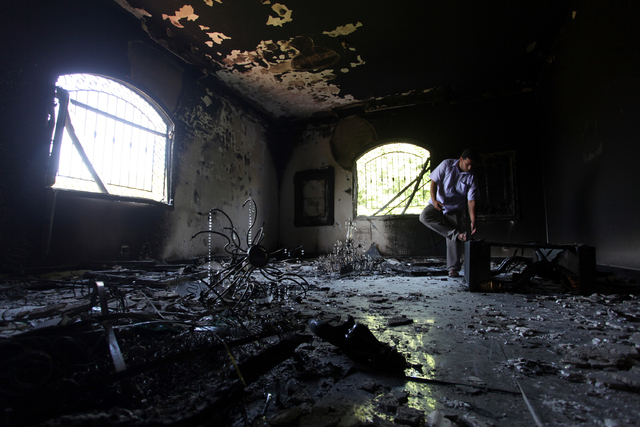 This Sept 13, 2012 file photo shows a Libyan man investigating the inside of the  U.S. Consulate in Benghazi, Libya, after an attack that killed four Americans, including Ambassador Chris Stevens. ...