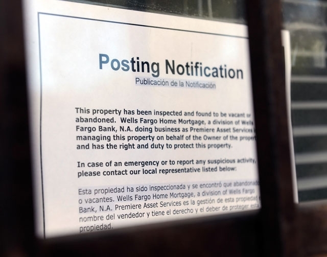 A foreclosure notice is posted on the window at a small condominium complex in Las Vegas in this 2012 file photo. (Review-Journal File Photo)