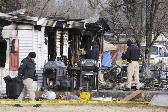 Kentucky State Police fire investigators at the scene of an early morning blaze Thursday at a home near Greenville, Ky. A mother and eight of her children were killed. (AP Photo/The Gleaner, Mike  ...