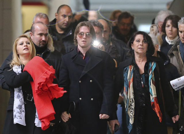 Raffaele Sollecito is flanked by his stepmother, Mara Papagni, left, and his aunt Sara Achille, right, as he leaves the final hearing before the third court verdict for the murder of British stude ...