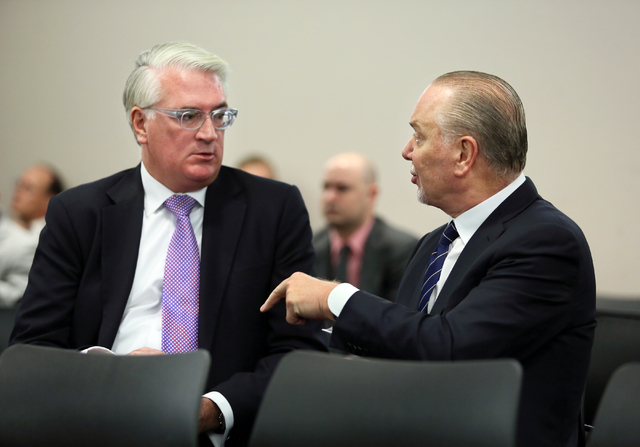 Attorney Mark Clayton, left, shareholder at Lionel, Sawyer & Collins, speaks with Lee Amaitis, president and CEO of Cantor Gaming, during a break of the Nevada Gaming Commission meeting at the Gra ...