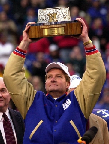 New York Giants head coach Jim Fassel holds up theNFC Championship trophy after defeating the Minnesota Vikings 41-0 Sunday, Jan. 14, 2001, in East Rutherford, N.J. (AP Photo/Bill Kostroun)
