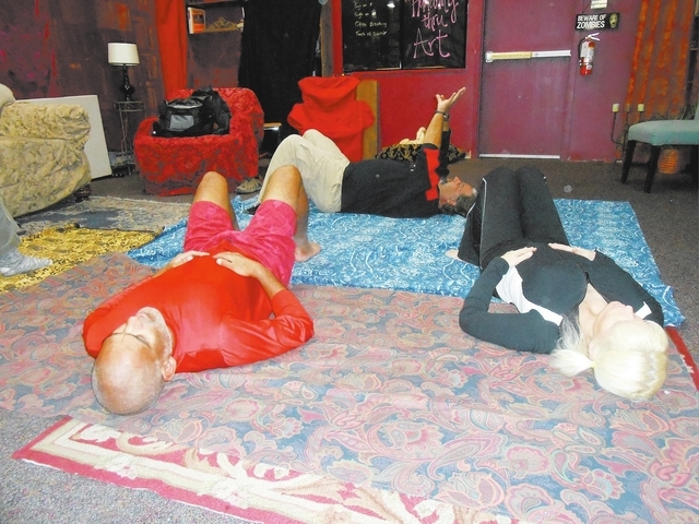 Attendees lie on the floor to facilitate deep breathing exercises Dec. 3 at Dead Poet Books, 937 S. Rainbow Blvd., led by Adam Littman, back row. Littman is founder of Humanity Thru Art, an organi ...