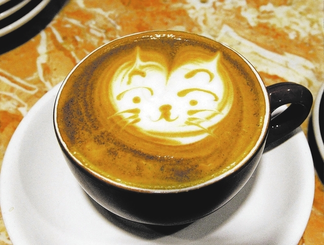 Barista Lawrence Chung, of Las Vegas, creates art in cups of latte at Leone Cafe in Tivoli Village. (Jerry Henkel/Las Vegas Review-Journal)