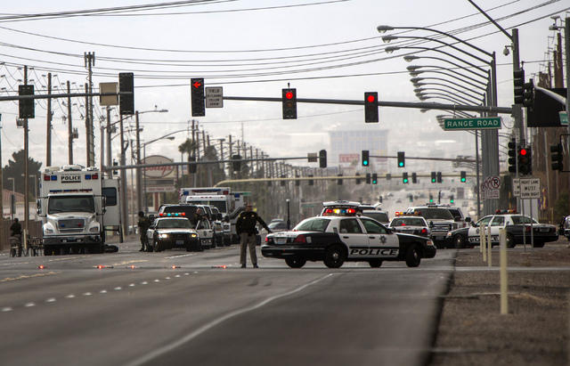 Law enforcement personnel gather outside Nellis Air Force Base at Las Vegas Boulevard and Range Road on Thursday. A man barricaded himself in the parking lot of the Mike O'Callaghan Federal Medica ...