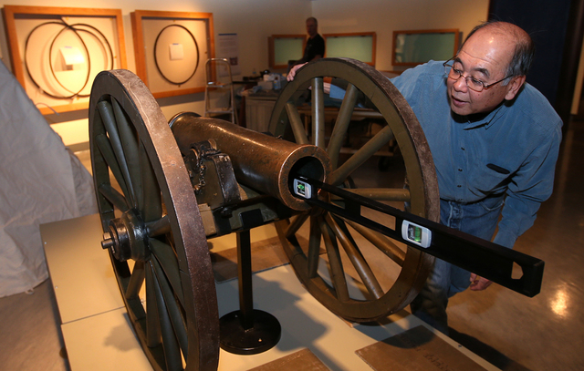 Nevada State Museum Archaeologist Gene Hattori checks a level while setting up the Fremont Cannon as part of the "Finding Fremont: Pathfinder of the West" exhibit at the museum in Carson ...