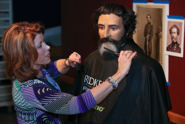 Hairdresser Vikki Thompson styles the hair and beard of the John C. Fremont mannequin at the Nevada State Museum in Carson City, Nev., on Monday, Jan. 27, 2014. The "Finding Fremont: Pathfind ...